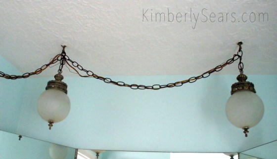 I love the way the heaviness of these contrasts with the light airy aqua color I painted our bathroom. And I love having a lot of light right by the bathroom mirror!